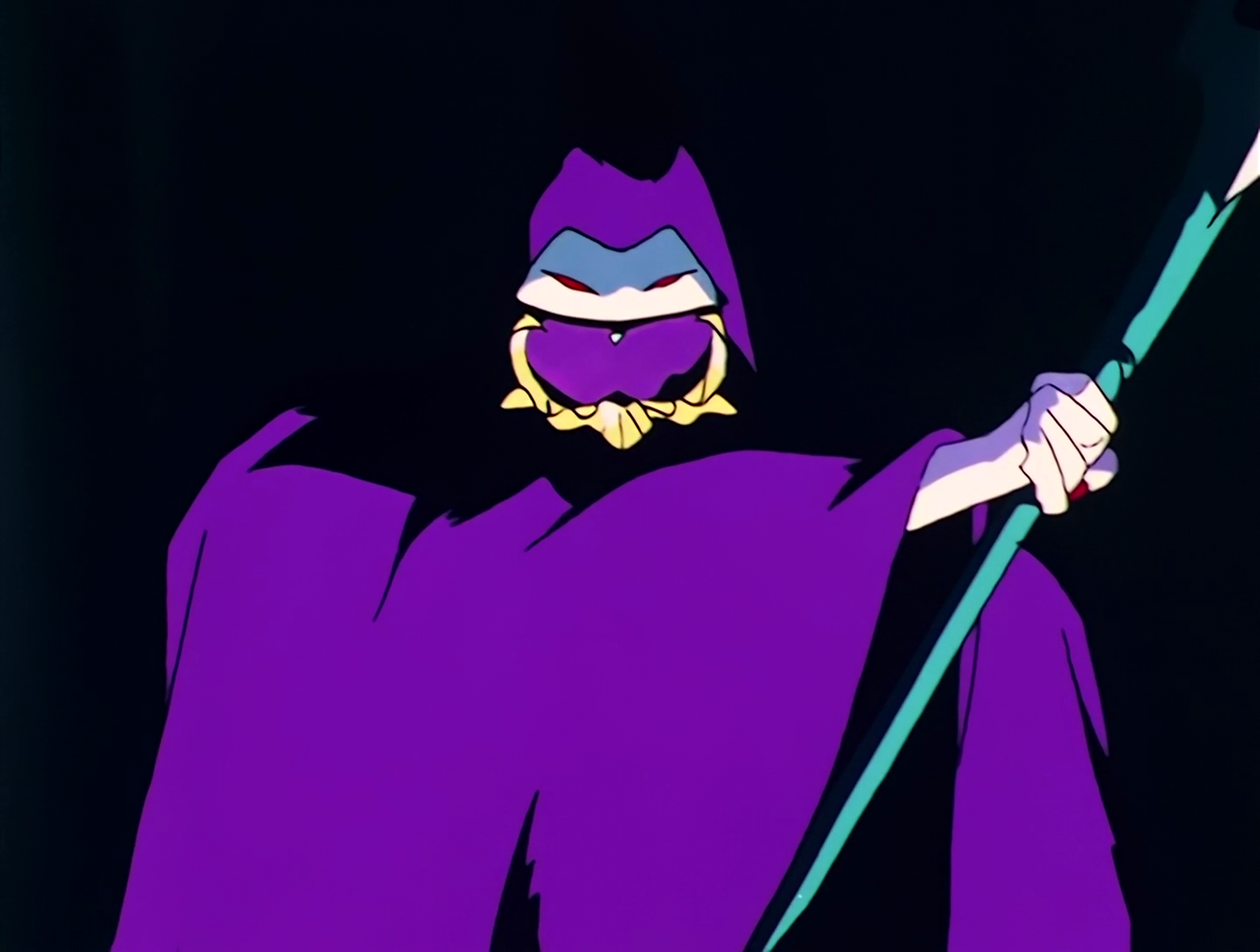 Jakoku, a Droid from Sailor Moon episode 75. He’s a pale figure dressed in a long purple cloak, but you can only see his arms and the top part of his face. He’s holding a scythe, though it’s cut off in the picture.